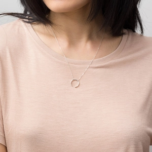 Close-up of hammered silver crescent moon pendant necklace on a stainless steel snake chain