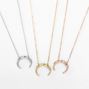 Three-piece set of crescent moon pendant necklaces in gold, silver, and rose gold finishes