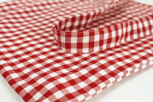 Detailed view of stitching on red and white gingham cotton linen shoulder bag