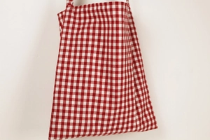 Detailed close-up showing the red and white gingham fabric pattern on a cotton canvas tote bag