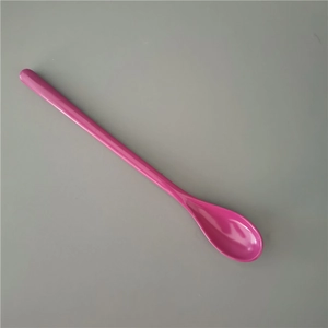Pink long-handled melamine dessert spoon with a smooth polished finish on grey background