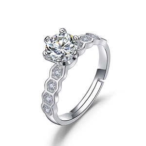Macro shot of silver six-prong ring featuring clear zircon and honeycomb diamond band