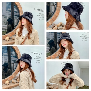 Multiple views of a thick black faux fur bucket hat providing winter ear protection
