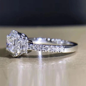 Macro view of square-cut central gemstone surrounded by micro-pave setting on silver ring