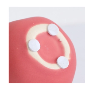 Dettaglio della base del melograno in ceramica rossa con gommini antiscivolo bianchi