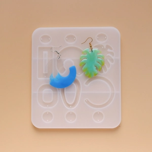 Detail of geometric silicone resin mold for DIY earrings with moon and leaf resin pendants