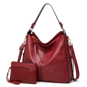 Detail view of burgundy PU leather tote bag with matching small pouch and zipper closure