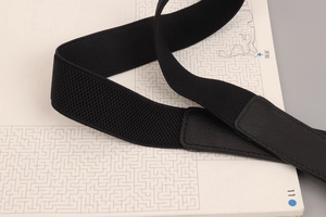Macro shot of black elastic waist belt featuring premium leather stitching and fine texture