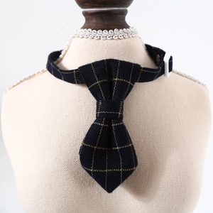 Detail of adjustable plaid pet bowtie with white buckle on a beige mannequin stand