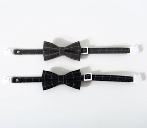 Close-up of adjustable pet bow tie collars in grey and black plaid fabric with plastic buckles