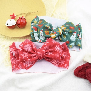 Close-up of Christmas style baby headbands featuring snowman and snowflake bow patterns