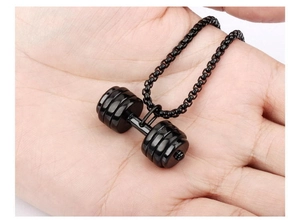 Close-up of black stainless steel dumbbell pendant necklace held in hand