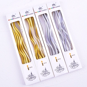 Macro shot of gold and silver curved spiral birthday candles in six-piece retail boxes