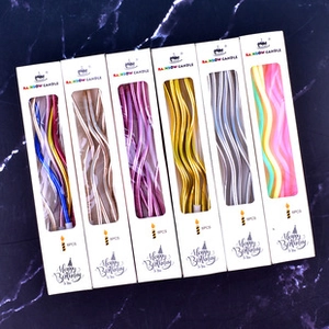 Group display of assorted colorful wavy birthday candles in premium PVC box packaging