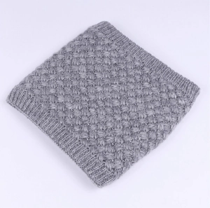 Detail shot of grey knitted snood scarf featuring thick ribbed texture and warm yarn fabric