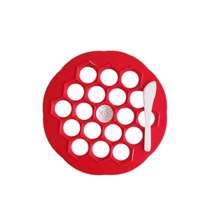 19-hole circular dumpling maker mold with red plastic press and white scraping tool