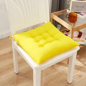 Bright yellow square padded seat cushion with nine-hole quilting and non-slip ties