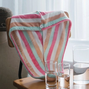 Detail view of striped microfiber hair towels in pastel colors with secure white button