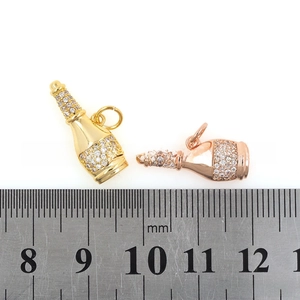 Detailed view of 18k gold plated wine bottle pendant with zircons and measuring ruler