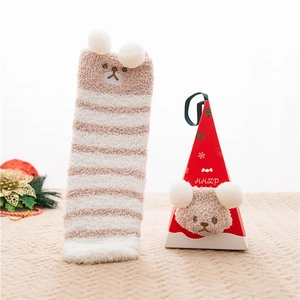 Detail view of khaki and white striped plush socks with cute bear embroidery and gift box