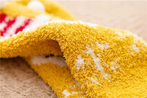 Close-up of thick yellow and white coral fleece fabric showing soft plush knit texture