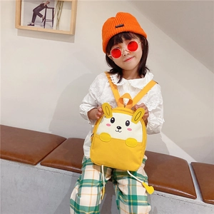 Detail of yellow canvas kids backpack with a cute white bunny and 3D long rabbit ears