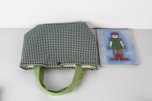 Flat lay of green gingham canvas tote bag with olive woven handles and art card
