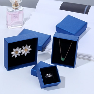 Peacock blue jewelry gift boxes for rings and necklaces on white display stands
