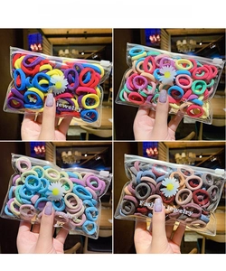 Detail of colorful elastic hair bands in a floral zipper pouch for girls and babies