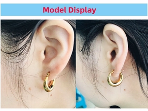 Close-up model view of chunky 18K gold plated hollow hoop earrings with mirror finish