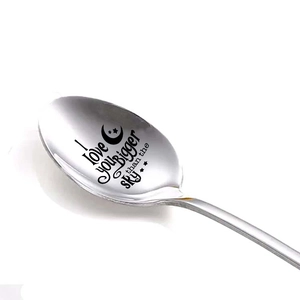 Macro shot of stainless steel spoon with I love you BIGGER than the SKY engraving