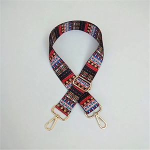 Detail of ethnic bohemian woven bag strap with golden metal lobster clasps and buckles
