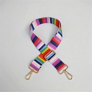 Close-up of adjustable wide colorful striped shoulder strap with gold metal buckles