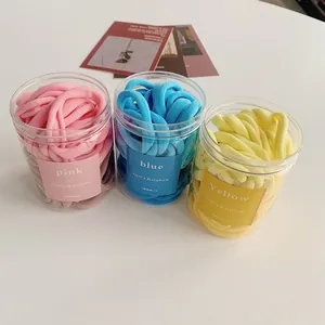 Rainbow gradient hair ties in pink blue and yellow jars with plush towel texture