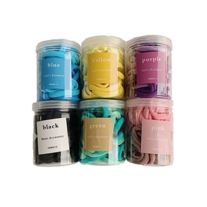 Set of rainbow gradient seamless hair ties in six colorful jars for girls hair styling