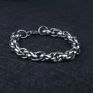 Detail of silver twisted cable chain link bracelet in polished stainless steel finish