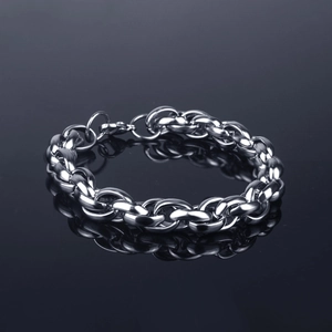 Polished silver stainless steel chunky chain bracelet with lobster clasp on dark reflective surface