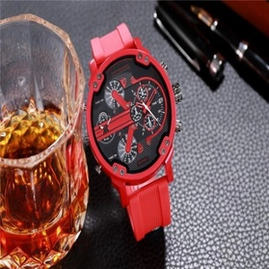 Detailed view of red multi-dial sports watch on black leather with a glass of whiskey