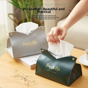 Action shot of pulling tissue from a green PU leather tissue box with snap buttons