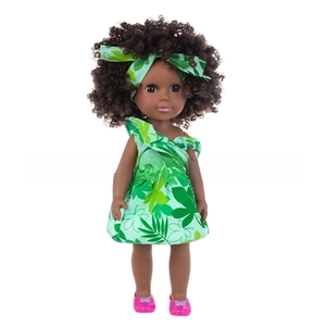 Detail of 14 inch African style doll with tropical leaf dress and curly hair