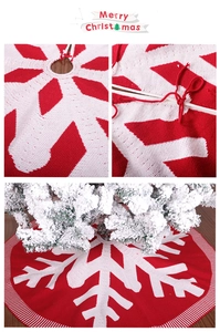 Detail of red and white knitted Christmas tree skirt with snowflake patterns and ties