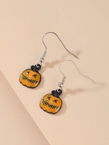 Detail of Halloween pumpkin drop earrings with orange and black enamel finish for women