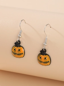 Detail of Halloween pumpkin earrings with orange enamel and silver metal hooks