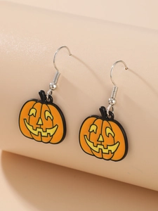 Close-up of orange acrylic Halloween pumpkin earrings with silver hooks and black outlines