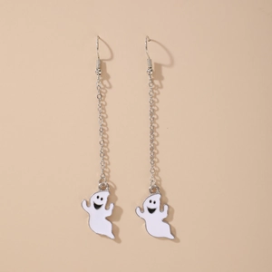 Detail of cartoon ghost earrings with silver chains and white enamel finish on cream background