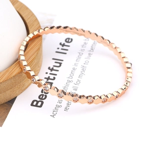 Macro detail of rose gold hexagonal honeycomb bracelet with sparkling zirconia stones
