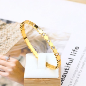 Macro view of gold hexagonal honeycomb bracelet with sparkling pavé cubic zirconia details
