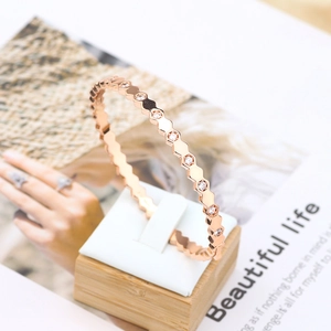 Macro shot of rose gold honeycomb hexagon bracelet with clear pavé cubic zirconia
