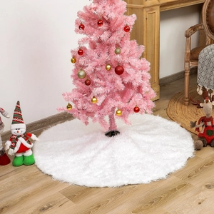 Detail of white faux fur Christmas tree skirt on wooden floor in cozy holiday setting