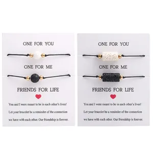 Detail of volcanic stone couple bracelets with magnetic beads on gift cards